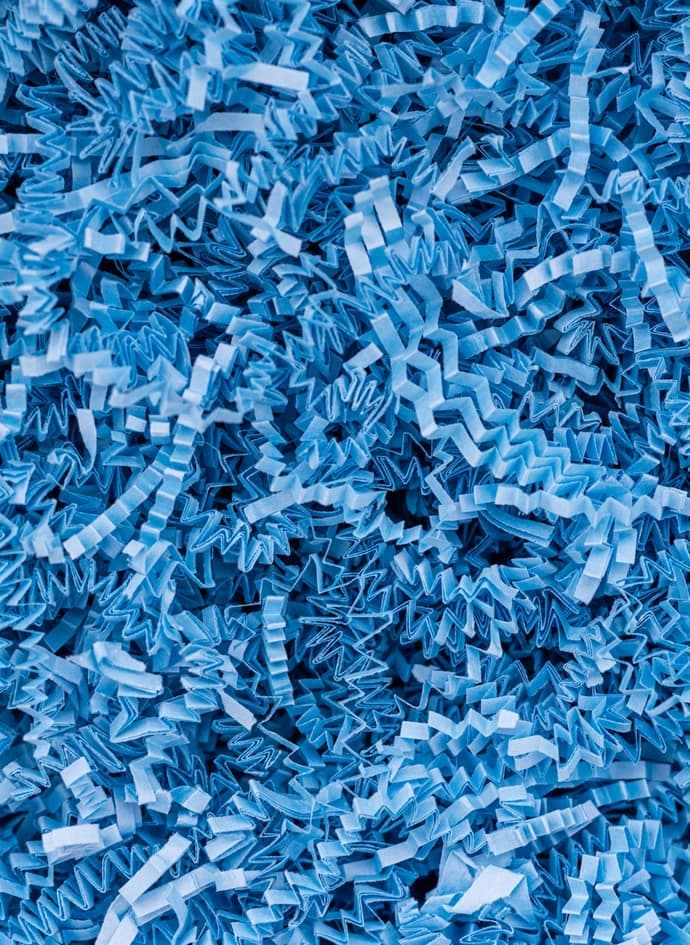 A pile of blue shredded paper.